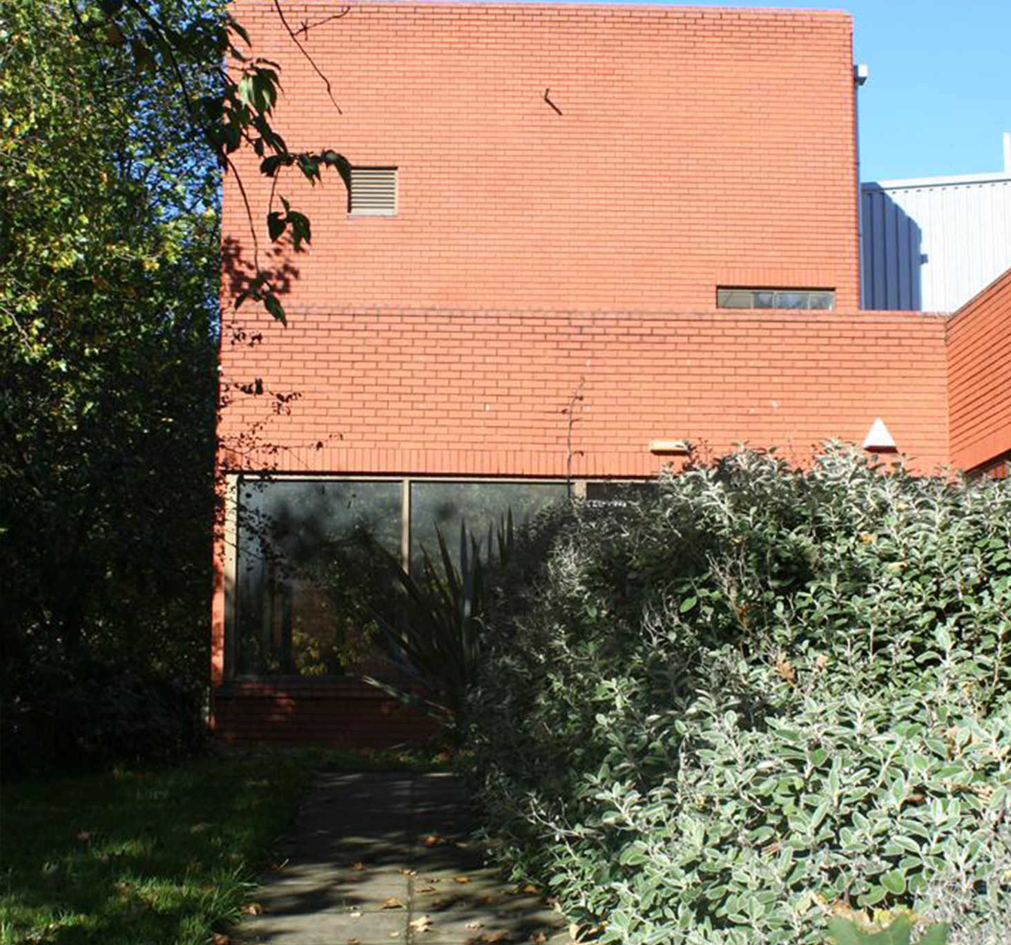 Exterior view of existing unit and roller shutter doors to the southwest of the site